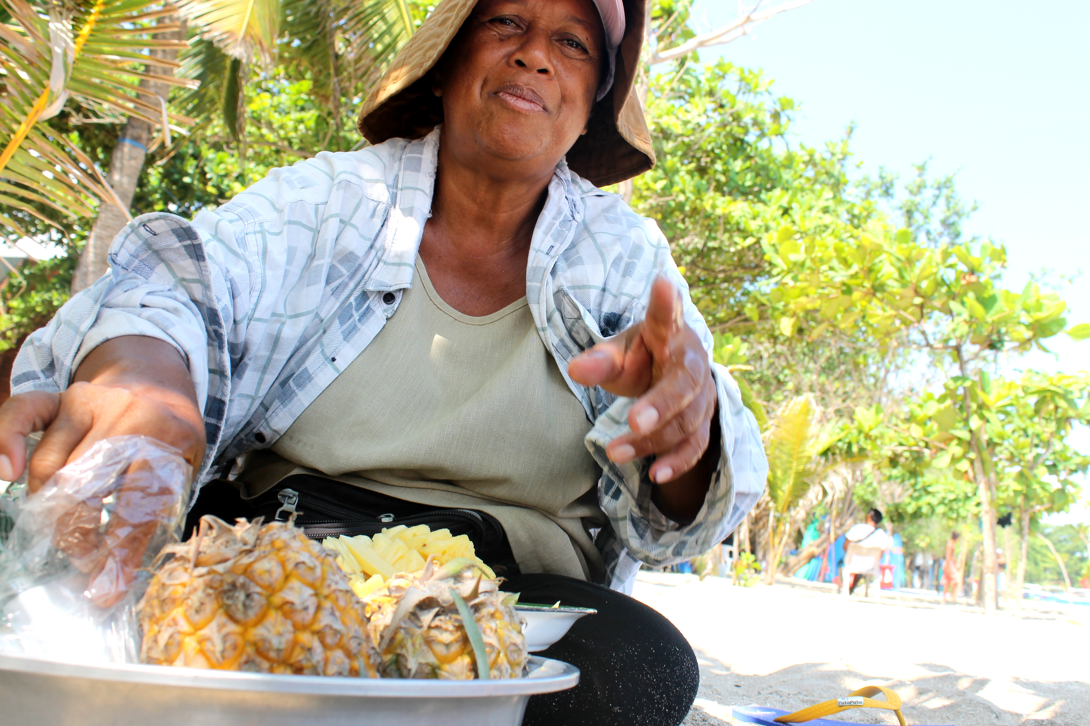 sprzedawczyni świeżych ananasów na plaży w Kucie